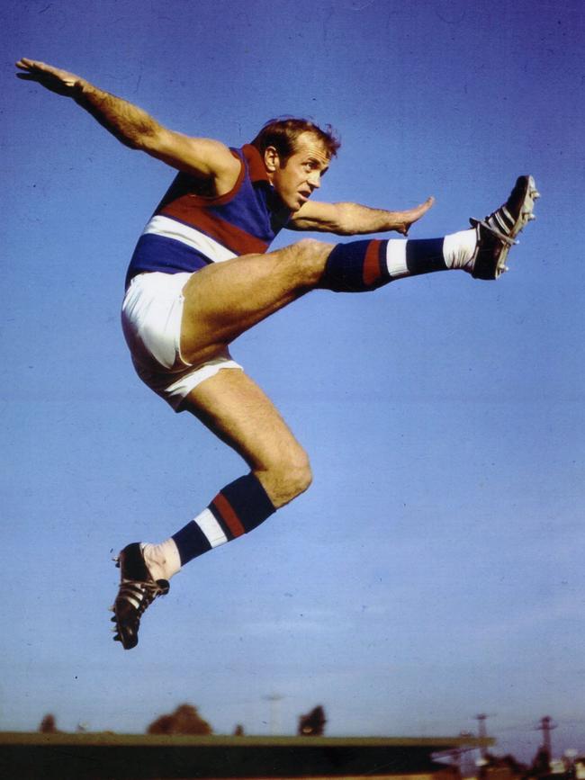 Footballer Ted Whitten in full flight..