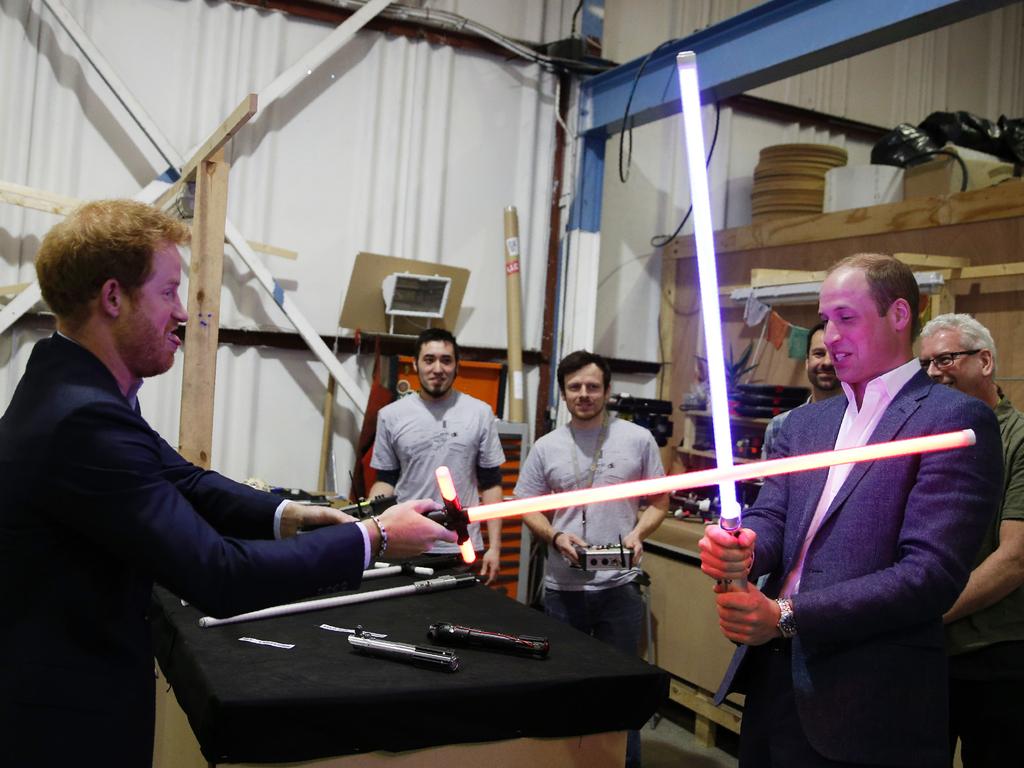 Britain’s Prince Harry and Prince William, Duke of Cambridge try out light sabres during a tour of the Star Wars sets at Pinewood studios in Iver Heath, west of London on April 19, 2016. Picture: AFP