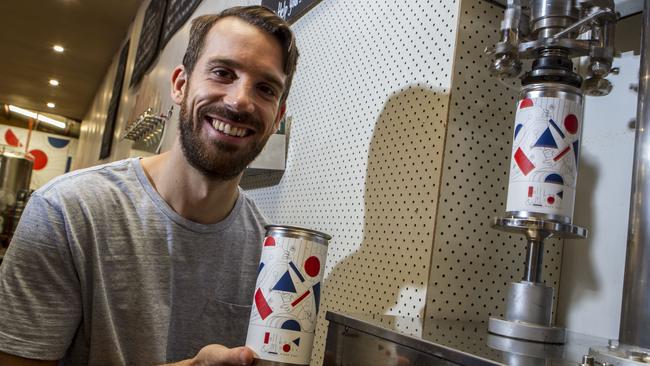 Steve Germain packs another Crowler, the one-litre can for takeaway Tallboy & Moose beers. Picture: Richard Serong