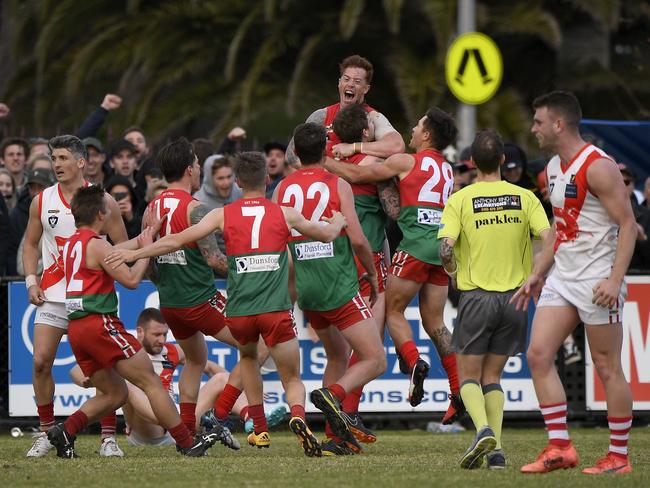 Aaron Ludewig is hoisted up by jubilant Pines teammates after the siren in 2018 MPNFL Division 1 grand final Picture: Andy Brownbill