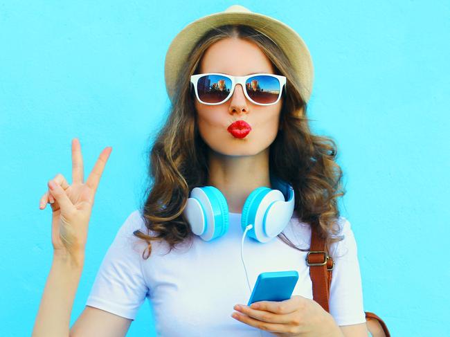 A woman is who using her smartphone while on holiday. Picture: iStock.