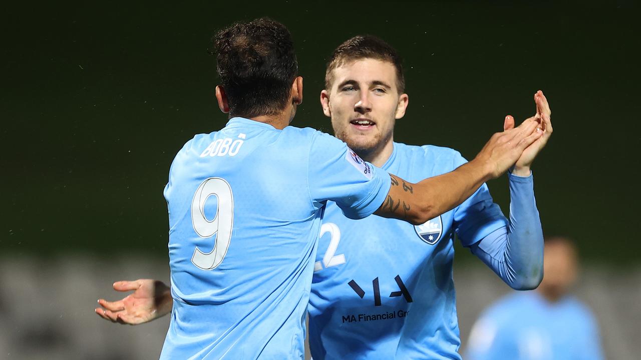 Bobo celebrates with his Sydney FC teammate Max Burgess. Picture: Mark Kolbe/Getty Images