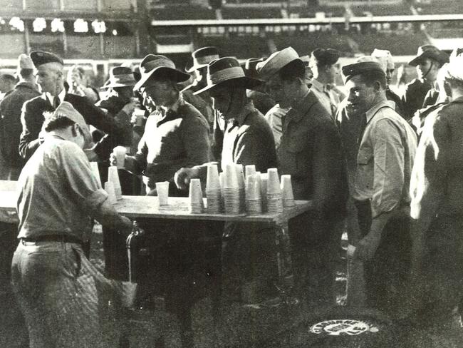 American and Australian soldiers enjoy a drink during a party at the Melbourne Cricket Ground.