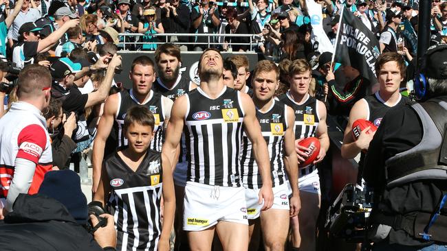 Travis Boak leads Port Adelaide out in the ‘prison bar’ guernsey for the 2014 elimination final at Adelaide Oval. Picture: Sarah Reed.