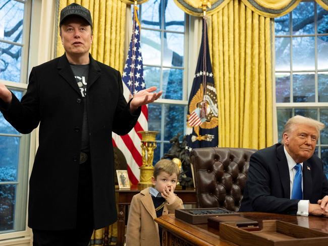 (FILES) Elon Musk speaks as his son X Ã A-Xii and US President Donald Trump look on in the Oval Office of the White House in Washington, DC, on February 11, 2025. In his near-100 days in power, President Donald Trump has signed a staggering number of executive orders -- an unprecedented 130 -- that topple many cornerstones of US policy. Straight after his January 20 inauguration, the Republican leader revoked 67 executive orders issued under his predecessor Joe Biden. Since then, he has signed edicts aimed at dismantling federal programs -- nearly half his orders go toward that, according to an AFP tally. (Photo by Jim WATSON / AFP)