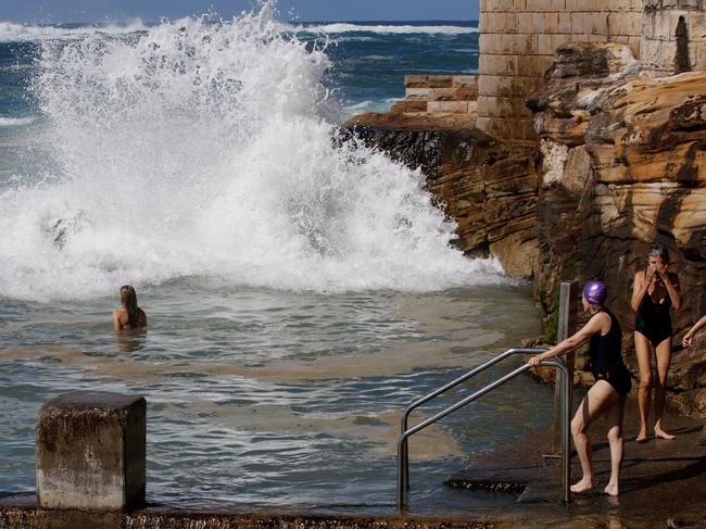 SYDNEY, AUSTRALIA - NewsWire Photos APRIL 18, 2025: People gather to watch large swell at Coogee Beach on Good Friday. The beach has been closed to the public with the Bureau of Meteorology issuing a hazardous surf warning for the coast of NSW. Picture: NewsWire / Nikki Short