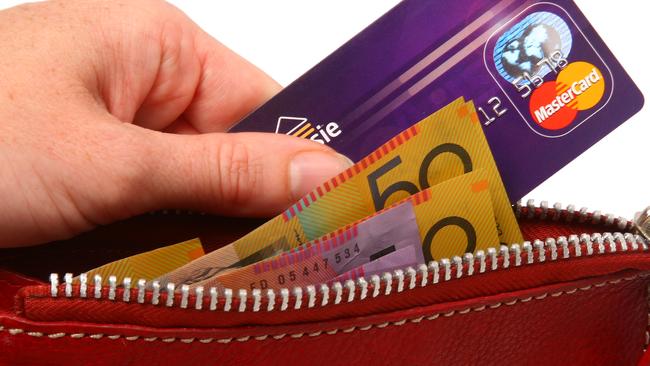 Generic Mastercard images. Mastercard credit card and money being pulled out of a wallet. Purse.