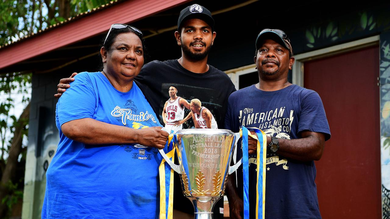 Rioli took the 2018 Premiership Cup to show his parents Georgina Vigona and Willie Rioli Sr. Picture: Justin Kennedy