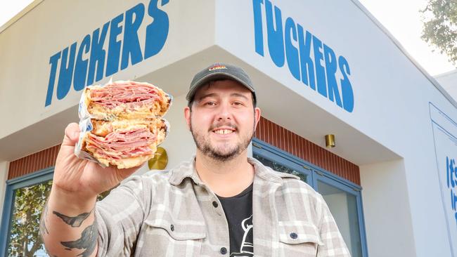 Title: Tucker's sandwich shop opens in Werribee Caption: Jon Ford, chef-owner of Tucker's Werribee, with one of his creations. Tuckers staff L to R Josh Michalowsky, Andres Villanueva, Jon Ford, Mackenzie Kelly and Santi Blick-Merta. Picture: Tim Carrafa