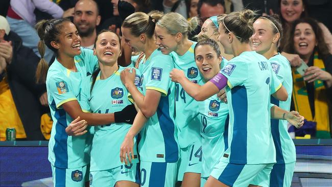 Matildas star Hayley Raso (second from left) celebrates with teammates.