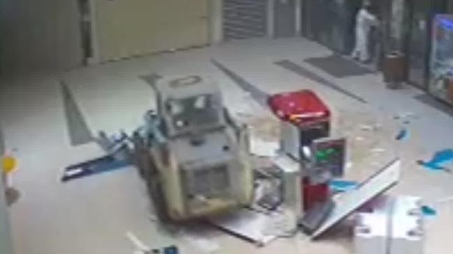 Police were called to a shopping complex following reports a bobcat had driven through the front doors