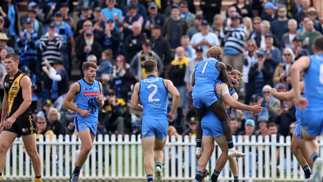 Sturt’s Martin Frederick (No. 1) and Steven Slimming hug teammate Patrick Wilson after the early Magarey Medal favourite kicked one of his three goals against Glenelg at Unley Oval on Saturday. Picture: Cory Sutton