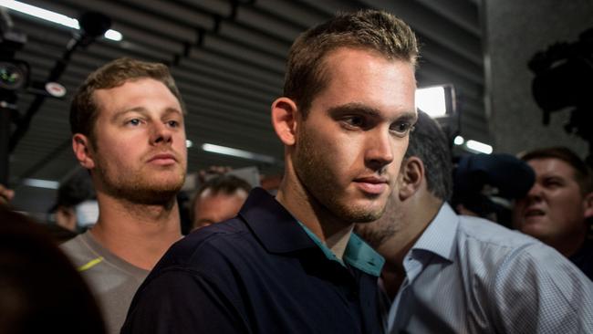 US Olympic swimmers Gunnar Bentz and Jack Conger leave the police headquarters at Rio de Janeiro