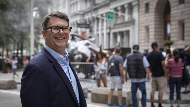 Former US. Ambassador and current president of the American Australian Association John Berry stands near the Charging Bull statue as tourists gather on Broadway in Manhattan, New York City on July 14. Picture: Andrew Kelly