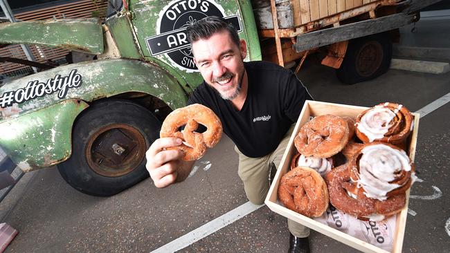 Owner of Otto's Fresh Food Market Don Peel with Otto's signature doughnut pretzels out the front of their new premises in Idalia. Picture: Zak Simmonds