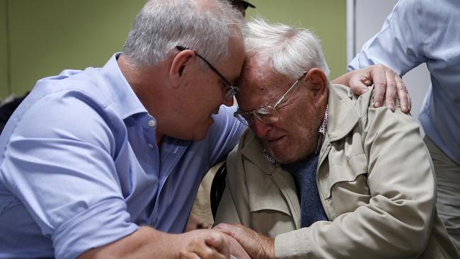 Prime Minister Scott Morrison comforts Owen Whalan, 85, who has been evacuated from his home in Taree.