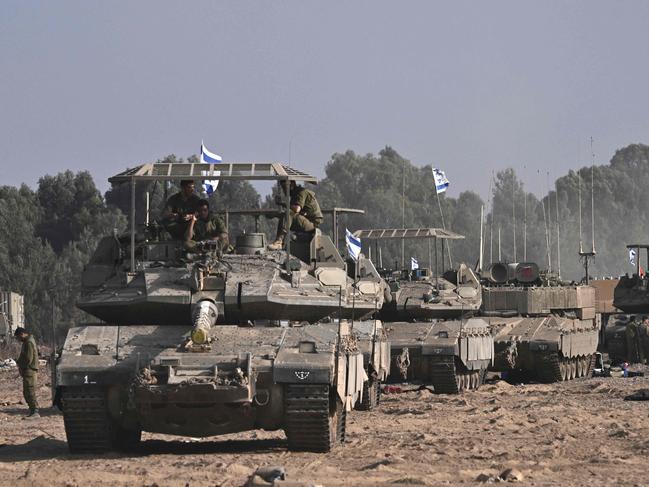 Israeli military armoured vehicles deploy along Israel's border with Gaza on October 24. Picture: Aris Messinis/AFP