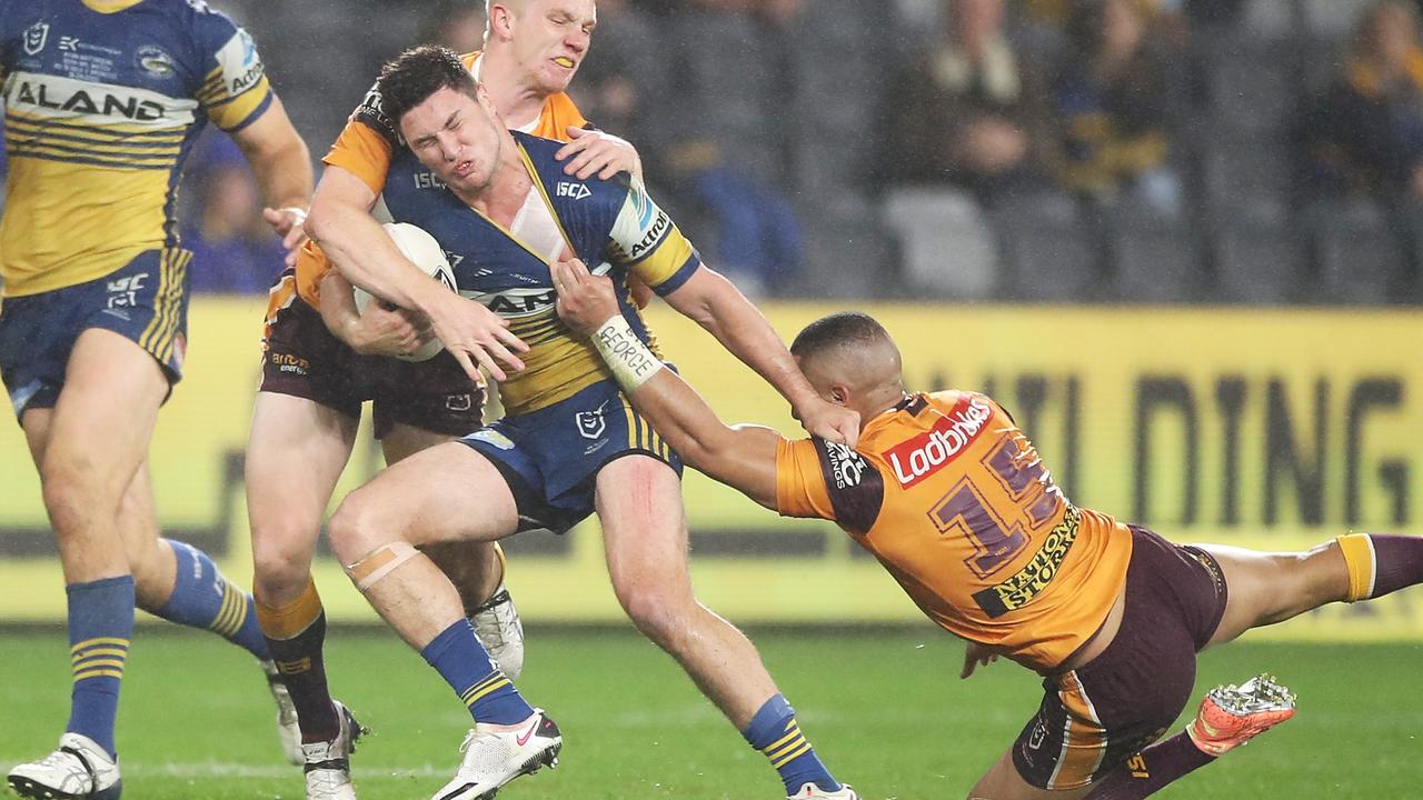 Mitchell Moses is tackled by the Broncos