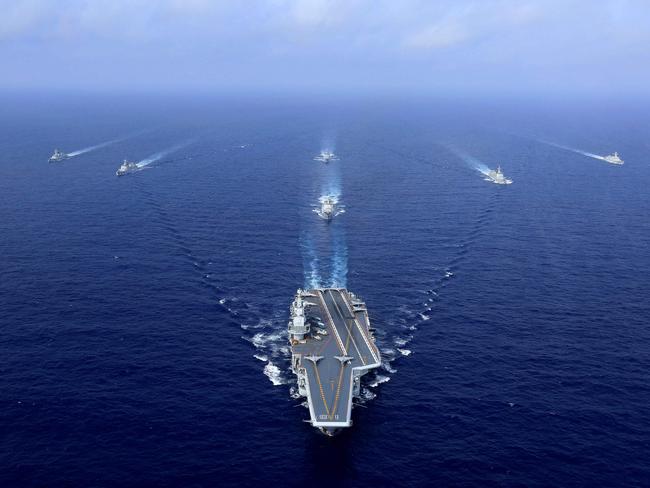 (FILES) This file photo taken on April 18, 2018 shows China's aircraft carrier, the Liaoning (C), sailing during a drill at sea. - China's accelerated military modernisation poses a clear and growing threat to Taiwan, and US intervention might only risk intensifying pressure from Beijing, US defence officials told reporters on March 15, 2021. (Photo by STR / AFP) / China OUT