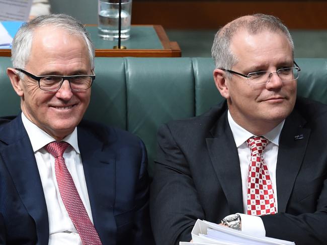 (L-R) Australian Innovation Minister Christopher Pyne, Australian Prime Minister Malcolm Turnbull and Australian Federal Treasurer Scott Morrison react during House of Representatives Question Time at Parliament House in Canberra, Wednesday, Dec. 2, 2015. (AAP Image/Lukas Coch) NO ARCHIVING