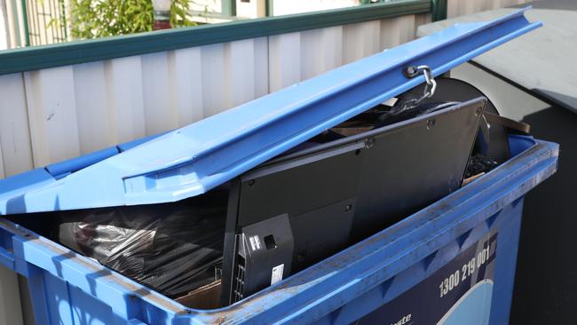 A TV in a bin outside a shot-stay rental house in Footscray where wild teenagers caused major damage after a party. Picture: David Crosling