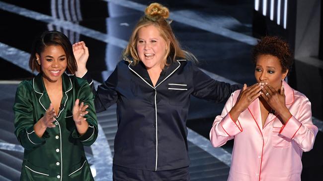 US actress Regina Hall, left , US actress and comedian Amy Schumer and US actress and comedian Wanda Sykes on stage at the Oscars. Picture: AFP.