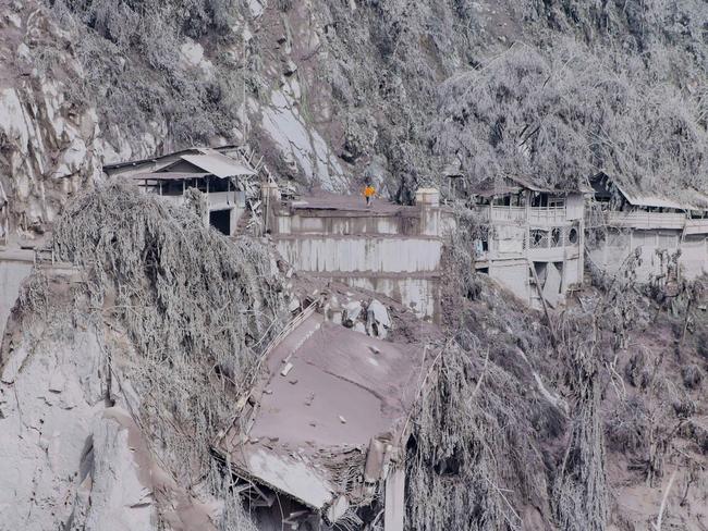 Ash covers houses and trees on the slopes of Mount Semeru in Lumajang after a volcanic eruption on the mountain that killed at least 14 people. Picture: AFP