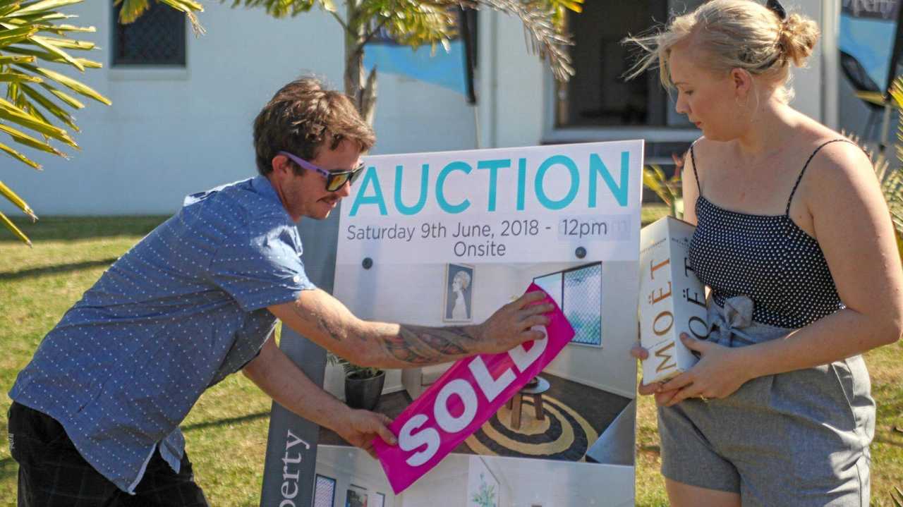 Kerry and Katie Warren just after snapping up their new home, 29 Cinnamon Drive, Glenella, at an Explore Property auction over the weekend. Picture: Navarone Farrell