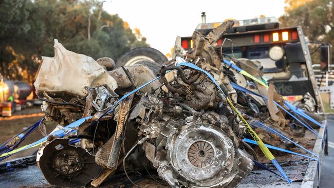 The Nissan, driven by a local woman at the time of the crash, is removed from the scene. Picture: Ian Currie