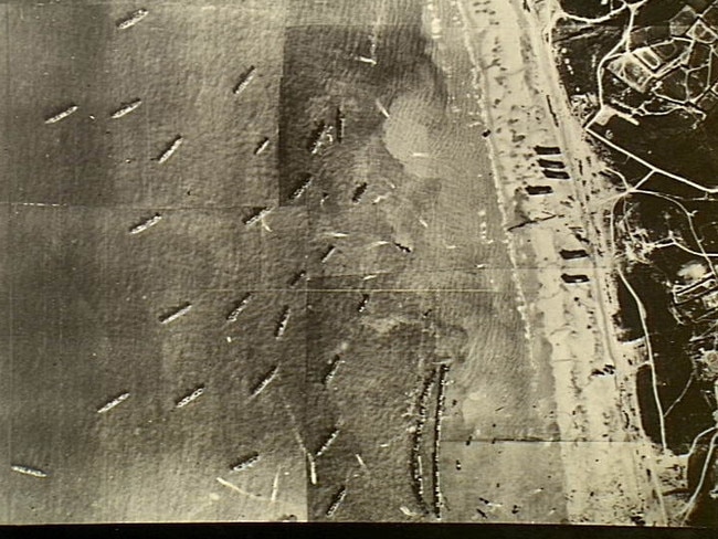 Securing the skies … an aerial view of Allied shipping and the artificial harbour at Arromanches, Normandy, towed across the Channel as part of Overlord to get supplies ashore quickly. It is possible to see the difference between the calmer water inside and the rougher outside the breakwaters. Courtesy of the Australian War Memorial