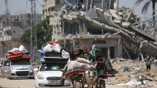 Displaced Palestinians arrive in vehicles carrying their belongings to set up shelter after returning to Khan Yunis in the southern Gaza Strip. Picture: AFP