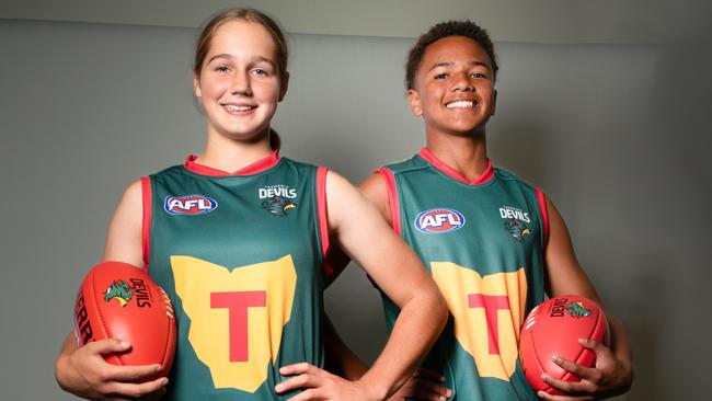 Mia Barwick and Shaun Kongwa sporting the new Tasmania Devils jumpers. Picture: Linda Higginson / Tasmania Football Club