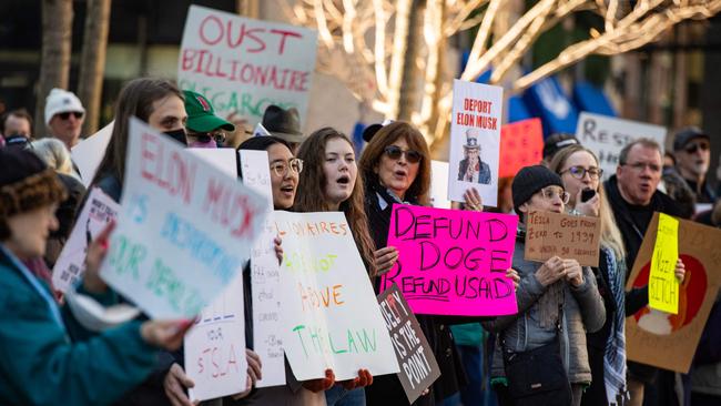 Protesters hold signs and sing chants during a protest against Elon Musk and his Tesla car company in Boston on March 15. Picture: Joseph Prezioso / AFP