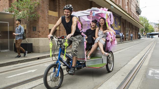 A trishaw — a cycle rickshaw — makes its way down a Sydney street.