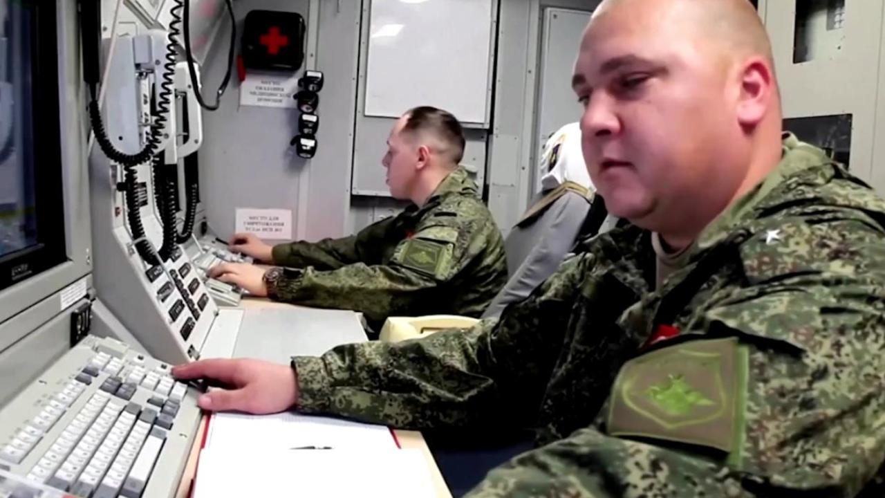 Military staff in a control room.