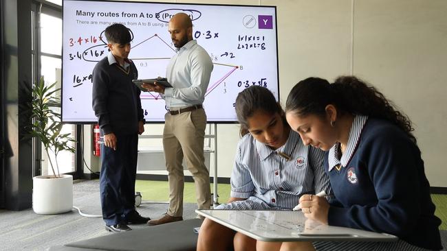 St John XXIII Catholic College master maths teacher Vikesh Gami with year 7 students. Picture: Jane Dempster