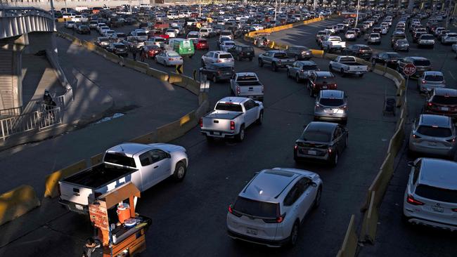 Commuters queue to cross to the United States at the San Ysidro Crossing Port in Tijuana, Mexico. Picture: AFP