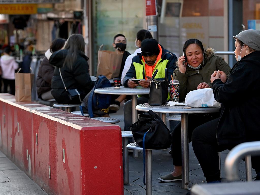 People not wearing face masks correctly gather at a food court on the main shopping strip of Bankstown in Sydney.