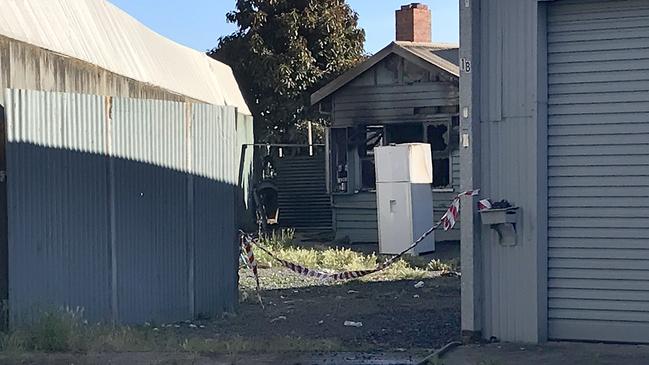 Stephen Edwards and Ella Williams with their two little boys Oliver (2) and Hudson (14 months) outside their destroyed rental property in South Burnie