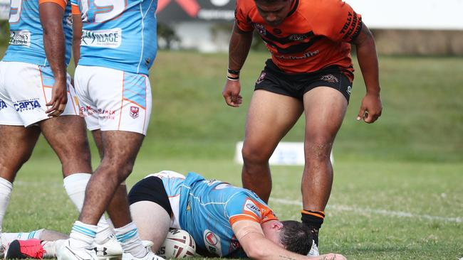 Mat Lamea stands over Colt Salmond after a heavy collision during the Round 2 match of the Lightning Challenge between the Northern Pride Reef Kings and the Tully Tigers, held at Stan Williams Park. PICTURE: BRENDAN RADKE