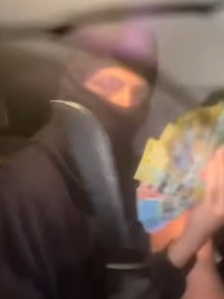 Kid with huge knife flashes cash in a stolen car on Instagram. Picture: Supplied