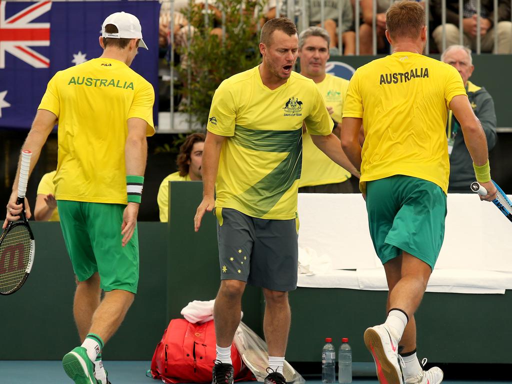 Australian coach Lleyton Hewitt celebrates with James Duckworth and John Peers.