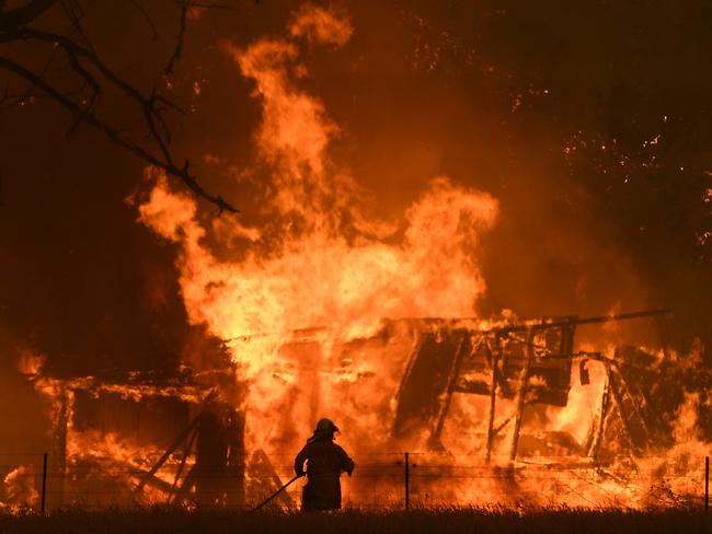 NSW Rural Fire Service crews fight the Gospers Mountain Fire as it impacts a structure at Bilpin, Saturday, December 21, 2019. Conditions are expected to worsen across much of NSW as temperatures tip 40C. (AAP Image/Dan Himbrechts) NO ARCHIVING