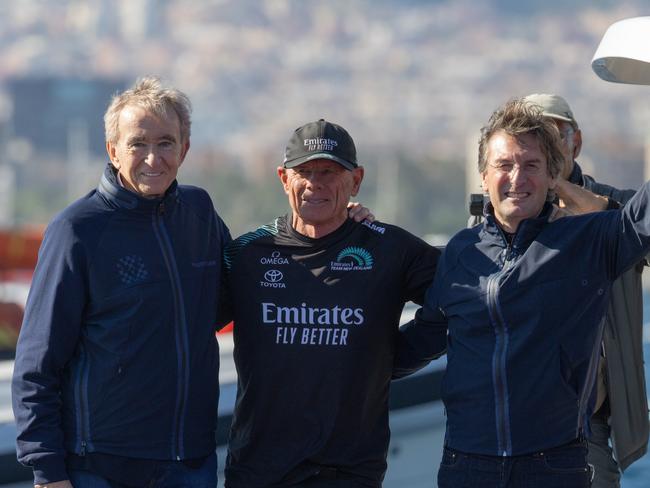 L-R: LVMH chairman and chief executive Bernard Arnault, Emirates Team New Zealand and America's Cup chief executive Grant Dalton and Louis Vuitton chairman and chief executive Pietro Beccari present The Auld Mug to the Emirates Team New Zealand team in Barcelona.