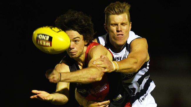 West Adelaide’s Hugh Haysman gets the handball away from South Adelaide’s Tom Fields.