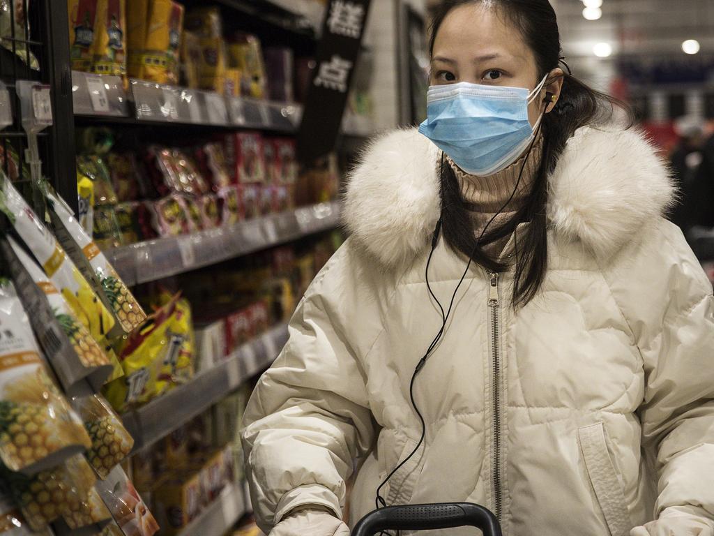 A woman wears a protective mask at a Wuhan supermarket. Picture: Getty Images