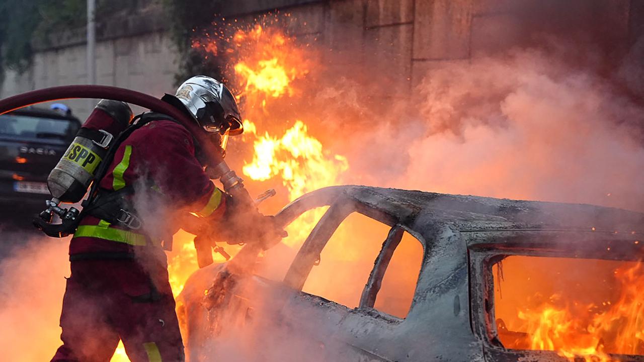 Youths set fire to dustbins, cars and buildings as authorities appealed for calm. Picture: AFP