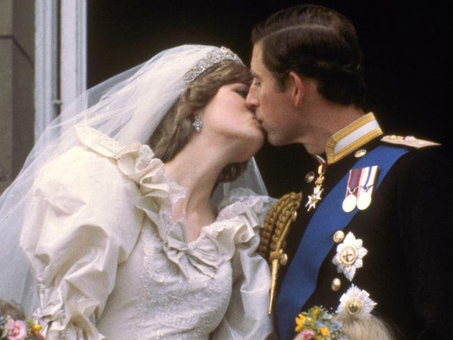 Prince Charles kisses his bride, Princess Diana, on the balcony of Buckingham Palace in London, after their wedding on July 29, 1981.