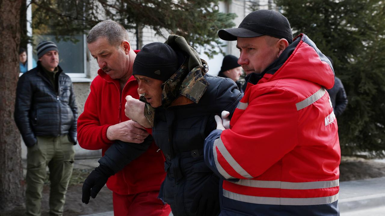 A patient is assisted by medical staff as he arrives at Novoiavorivsk District Hospital. Picture: Dan Kitwood/Getty Images