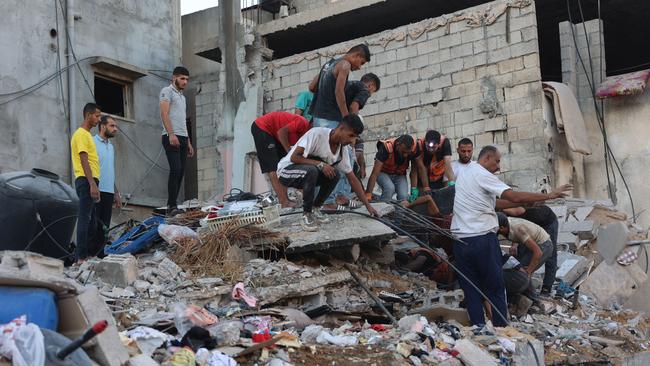 Palestinian medics dig through the rubble of a building searching for survivors after an Israeli air strike. Picture: Omar Al-Qattaa/AFP